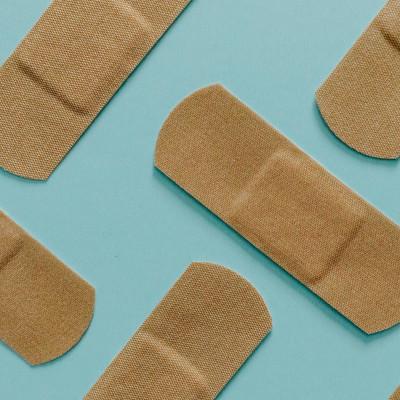 Band-Aids on a teal background.